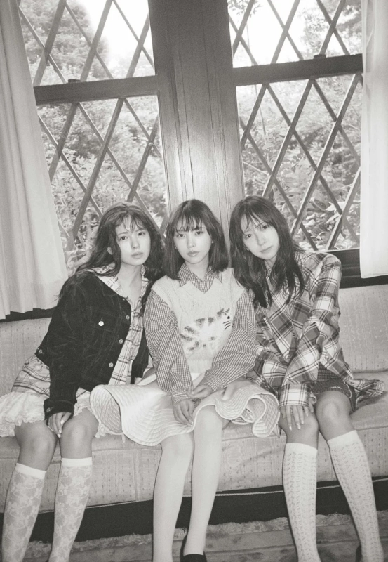 Three women sitting on a sofa