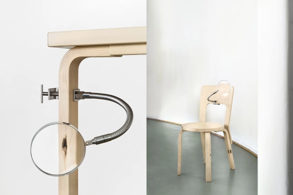 Close-up of a wooden chair with a magnifying glass highlighting a knot