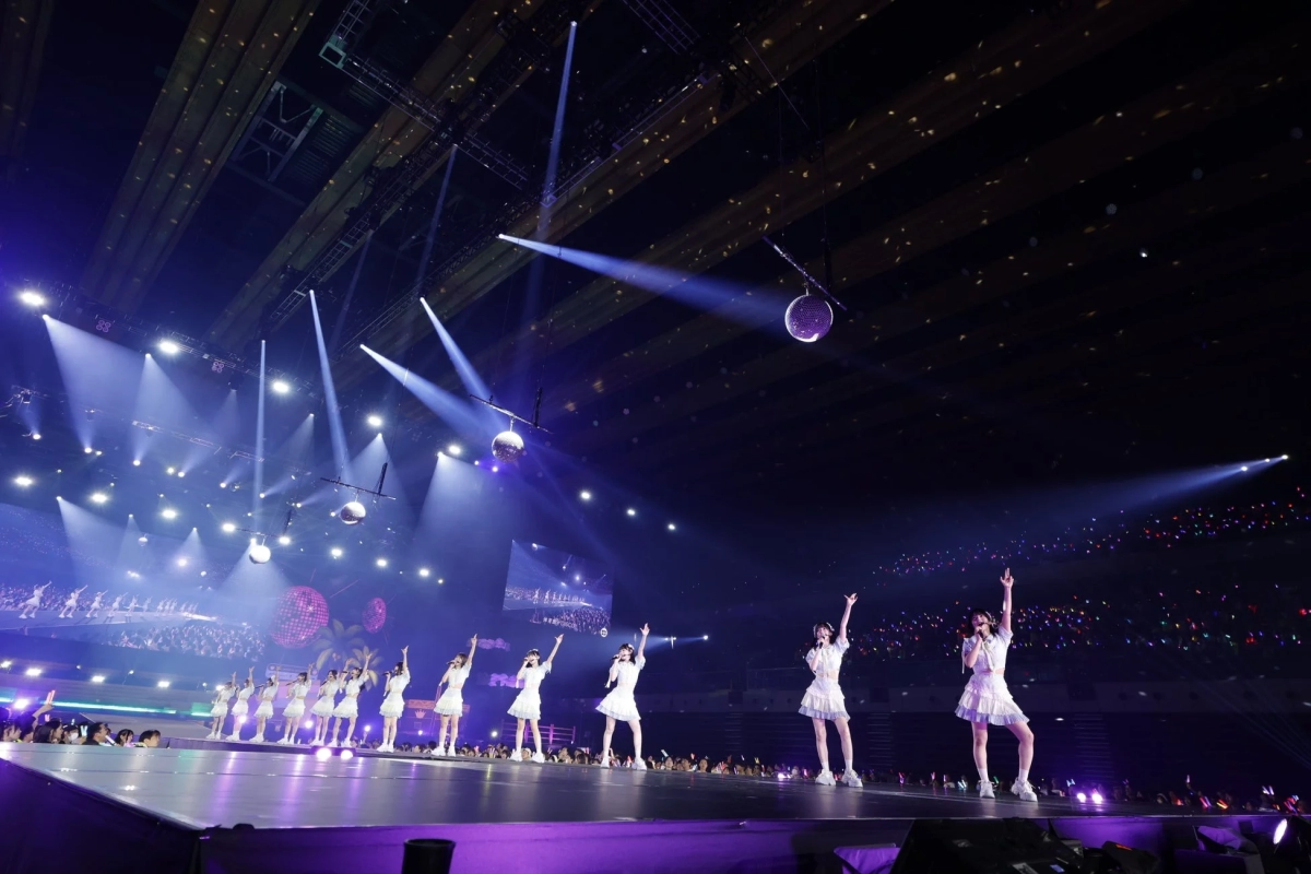 ≒JOY performing on a brightly lit stage with many fans