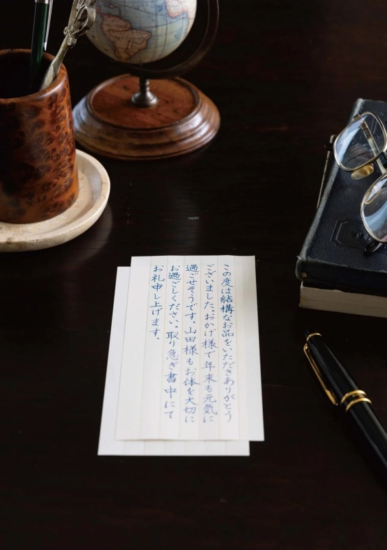 Handwritten thank you note on a desk