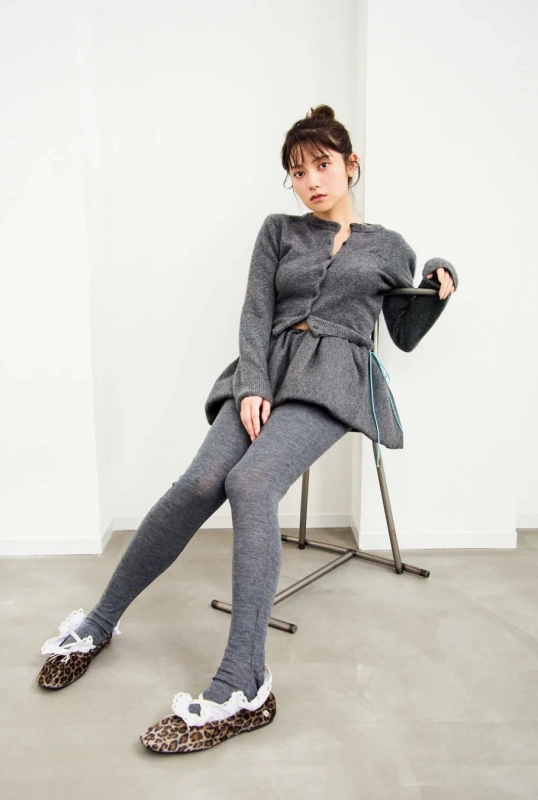 Woman in a gray knit cardigan