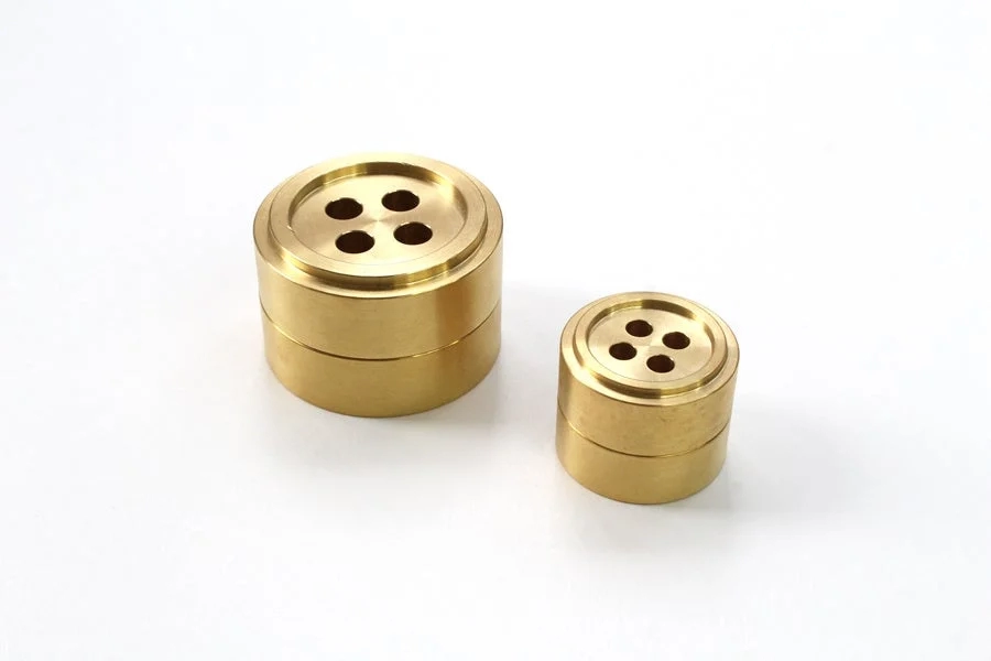 Two brass paperweights, one larger and one smaller