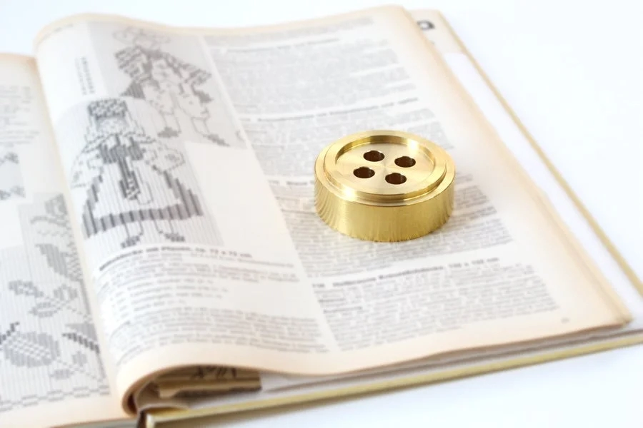 Two brass paperweights on an open book