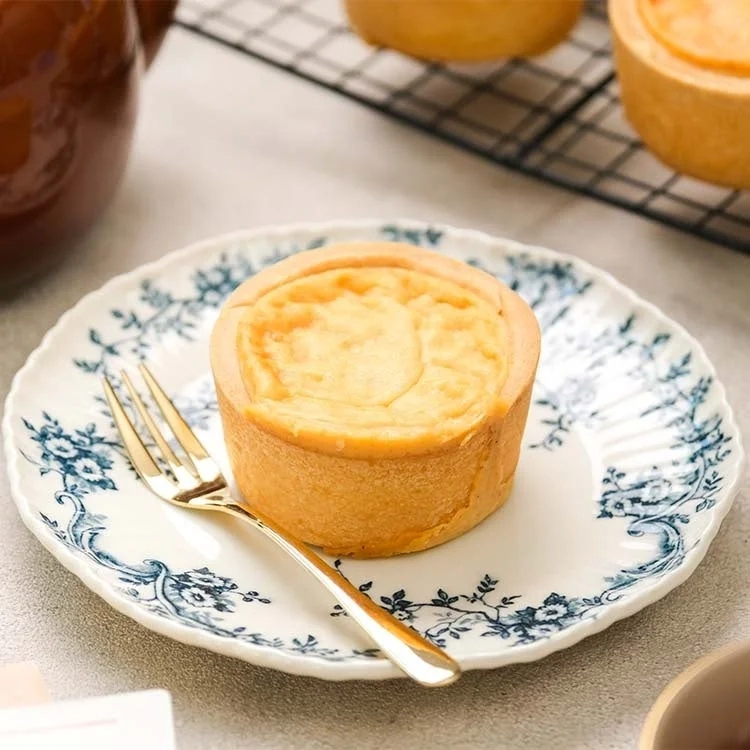 Baked tart with a fork on a patterned plate