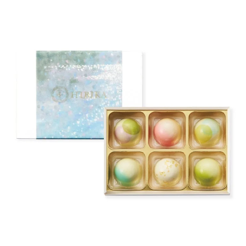Assortment of six pastel-colored round chocolates in a gift box