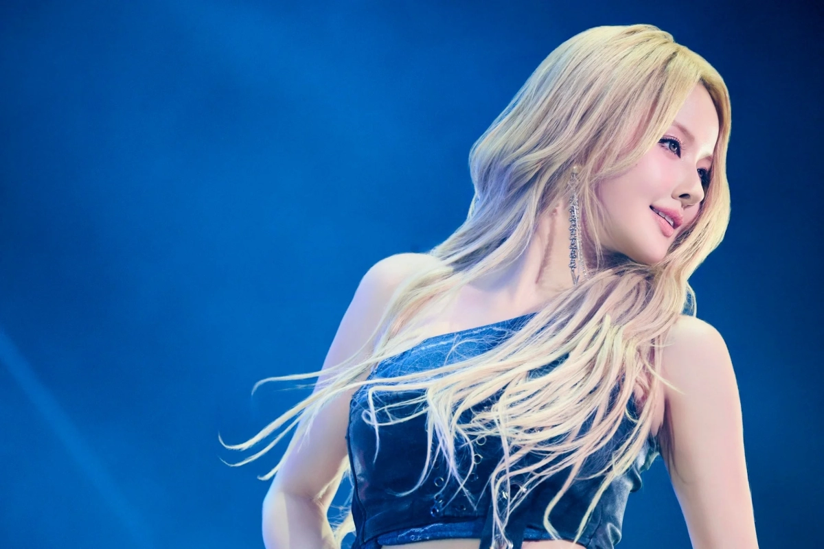 Close-up of a blonde woman, likely Belle, on stage