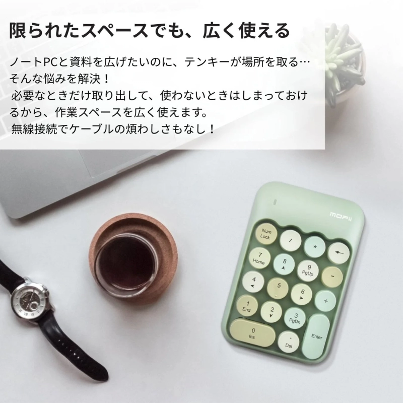 Green Typewriter-Style Numeric Keypad next to a laptop