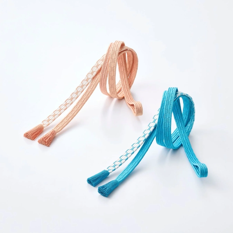 Two elegant Obijime cords in peach and light blue, featuring white braided patterns and delicate tassels.