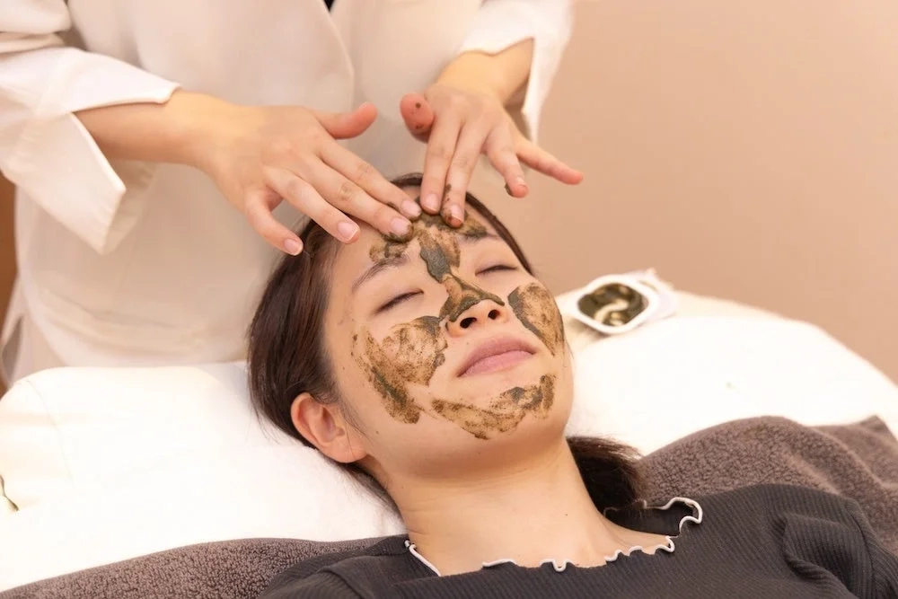 Woman receiving facial mask