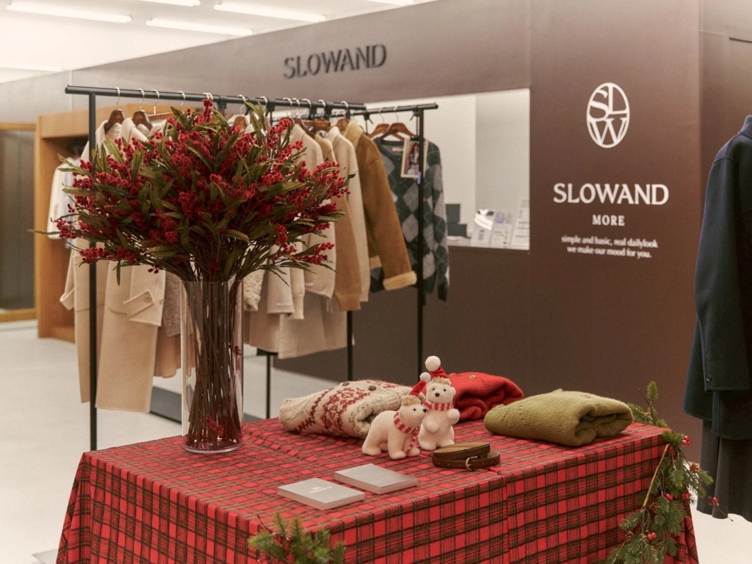 SLOWAND store display with winter fashion and festive elements.