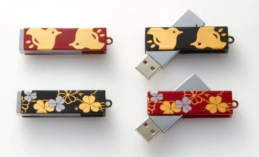 Red and black USB flash drives with Japanese bird and clover patterns