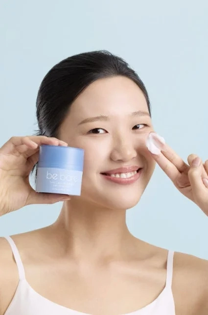 Woman applying face cream