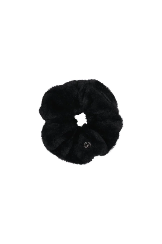 A black fluffy faux fur scrunchie with a small silver logo charm is displayed against a white background.