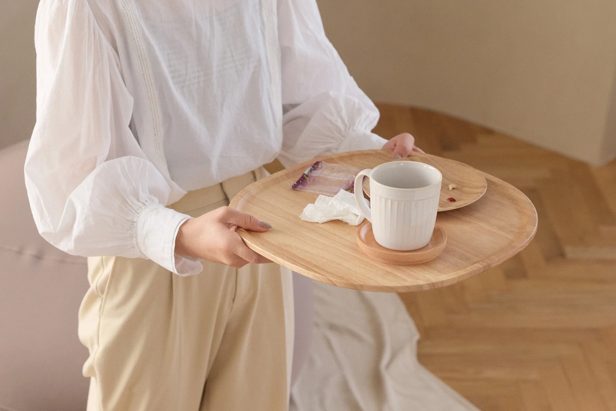 Woman holding the wooden tray