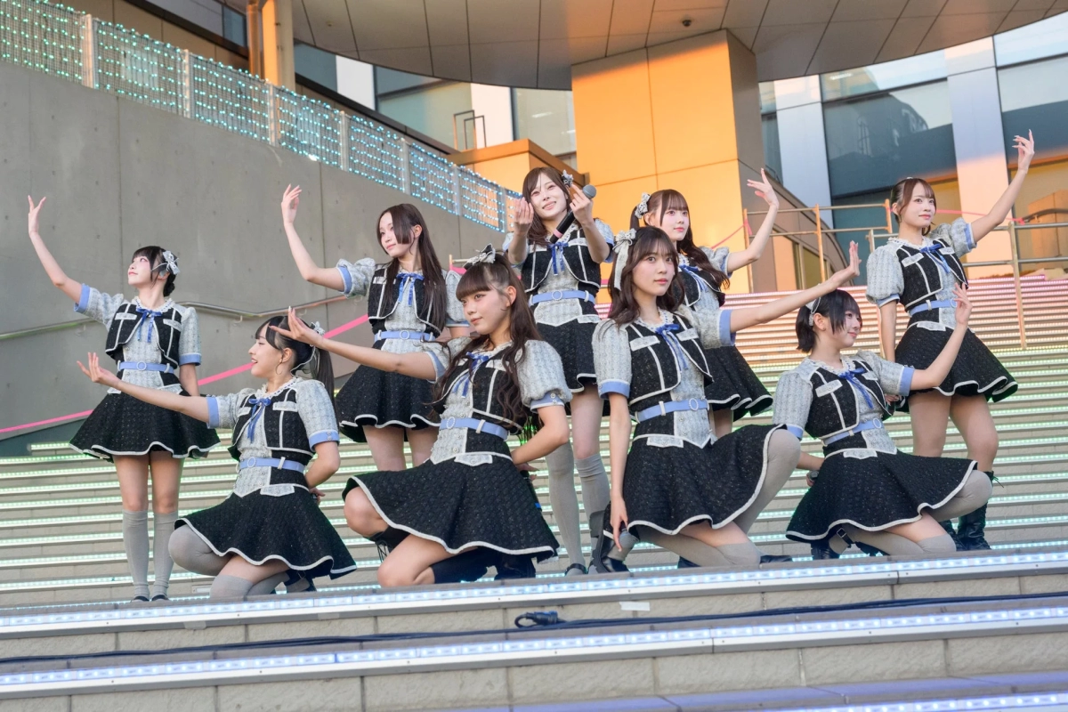 Female idol group performing on an outdoor stage