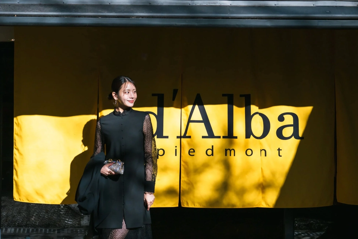Woman in front of d'Alba Banner at Happo-en