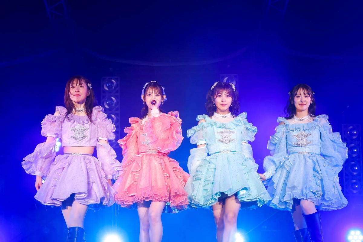 TEAM SHACHI members performing in frilly, sparkling costumes