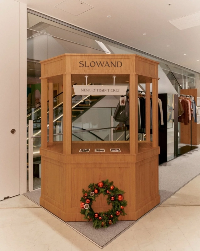 A wooden counter with a "SLOWAND MEMORY TRAIN TICKET" sign and festive decorations.