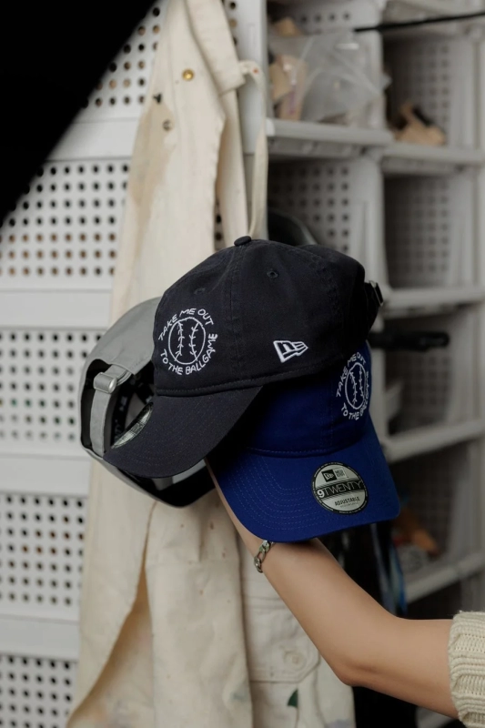 Caps held, showcasing artwork