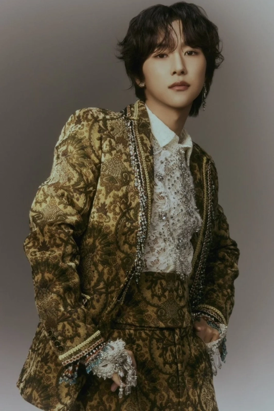 A portrait of a young man with elegant fashion and accessories.