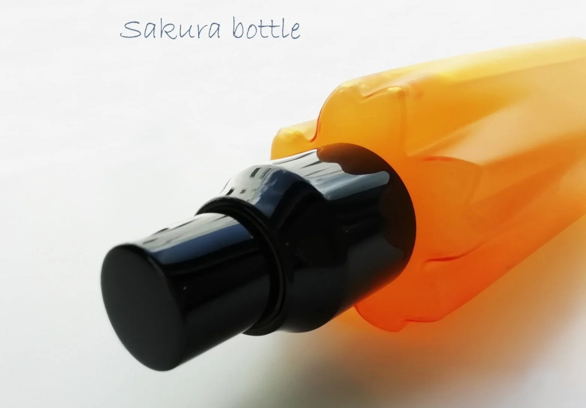 A close-up of the orange "Sakura bottle" of the hair mist.