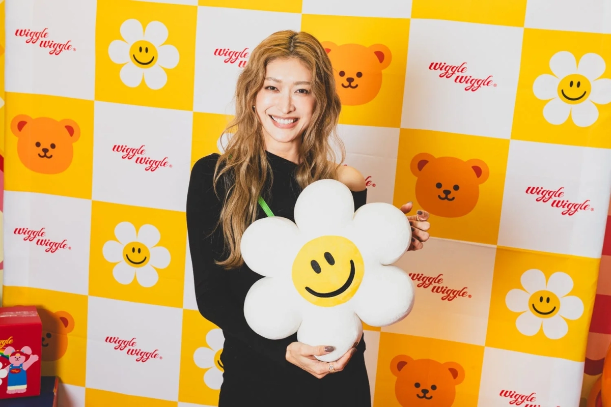 Smiling woman with floral cushion