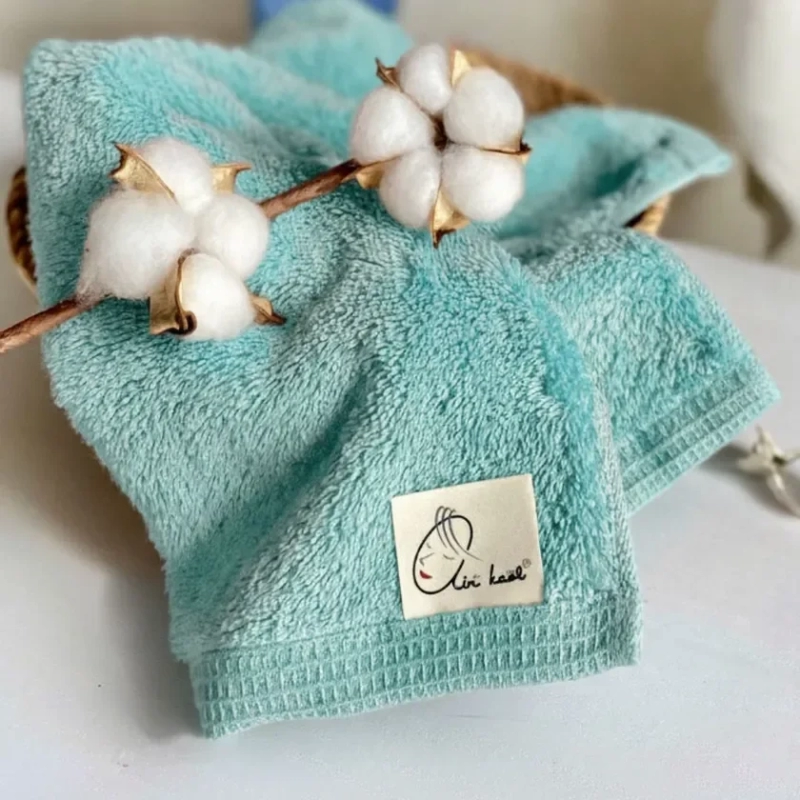 Fluffy blue towel with cotton branch