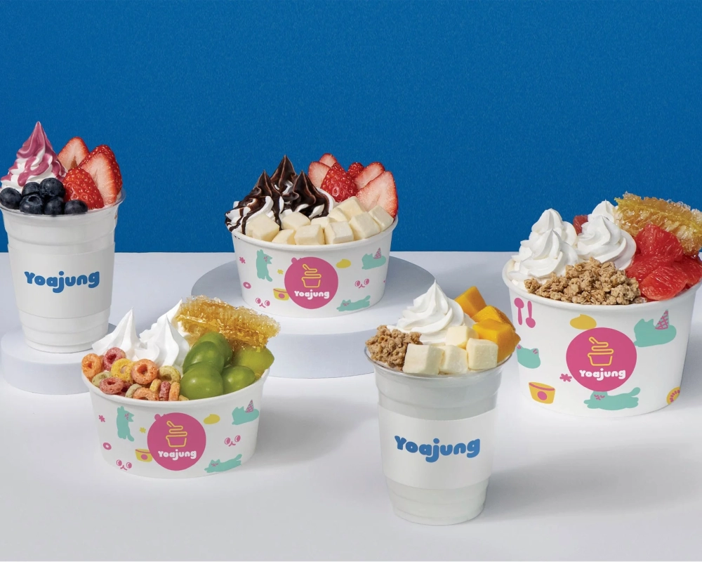 Assortment of YOAJUNG frozen yogurts with various toppings