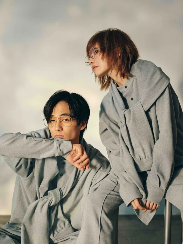 Two models wearing grey relaxed apparel and glasses