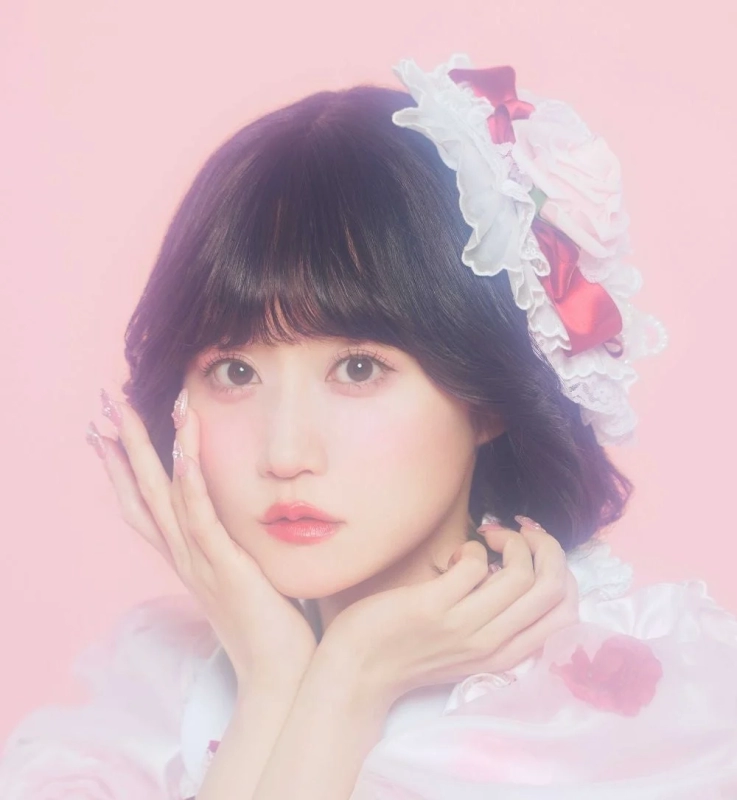 Yui Ogura in a soft pink setting, embodying retro charm