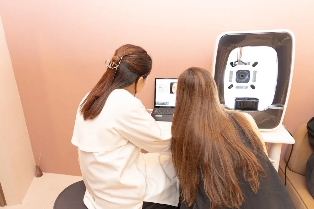 Women looking at skin analysis results