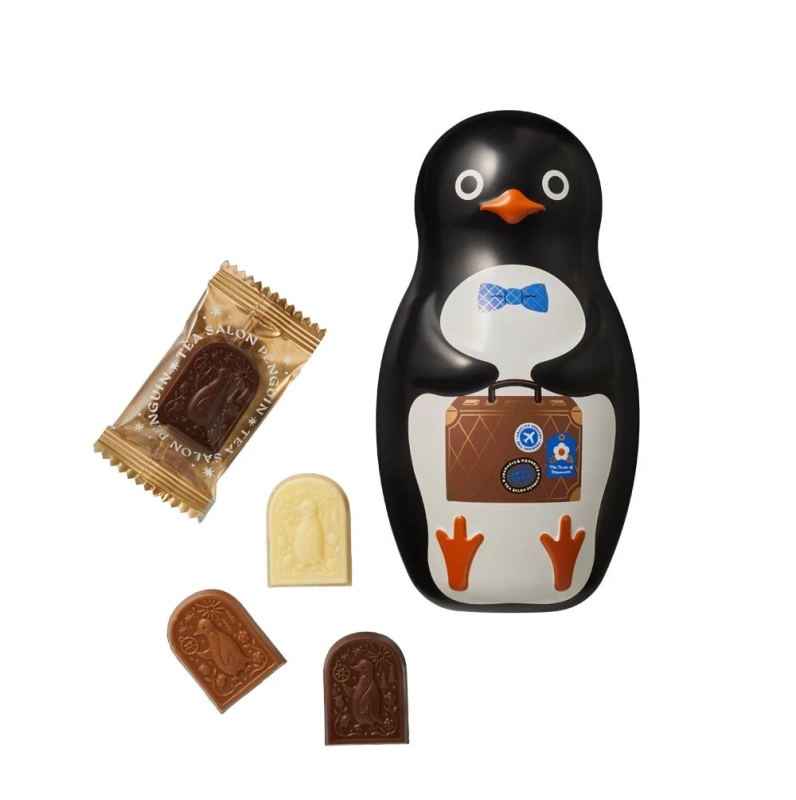 A cute penguin-themed tin filled with various penguin-shaped chocolates.