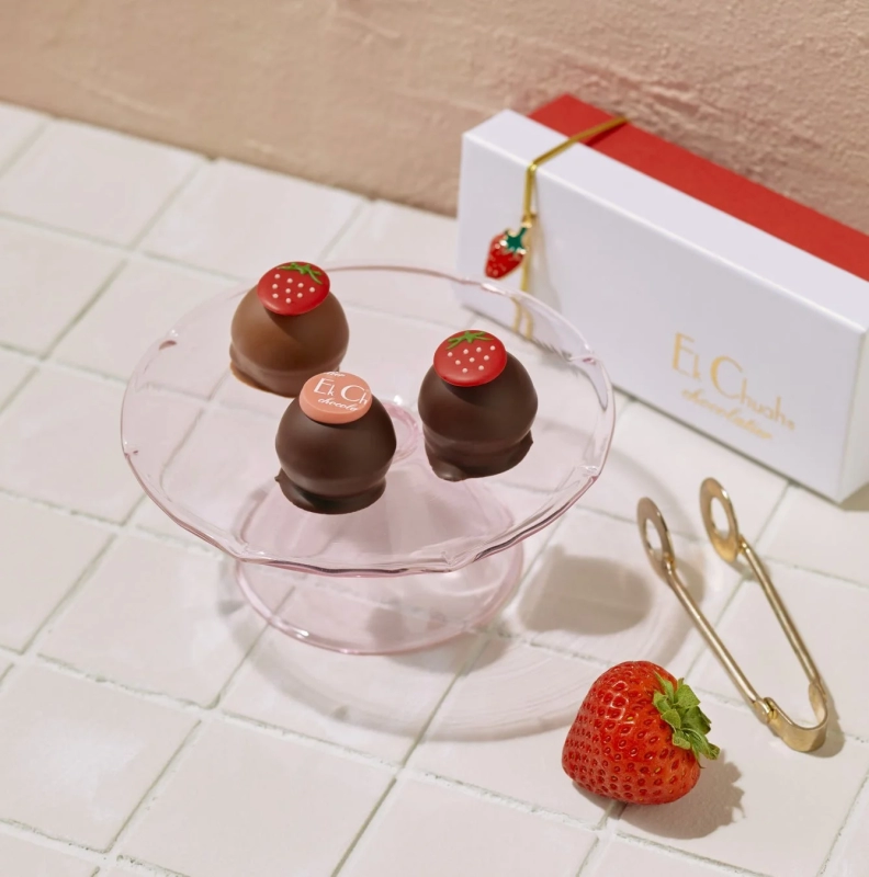 Strawberry chocolates on a pink cake stand