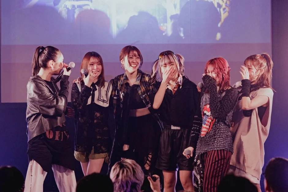 Finally members smiling and performing on stage