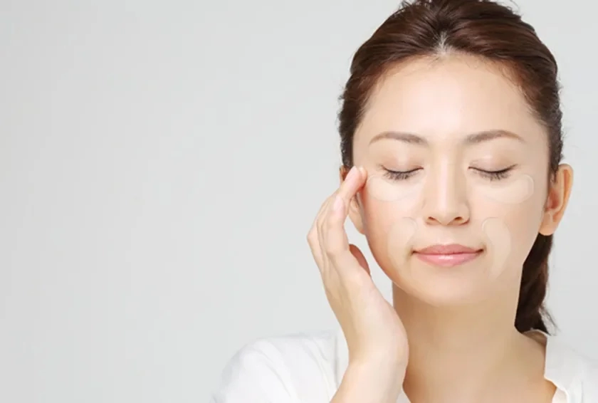 Woman using eye patches
