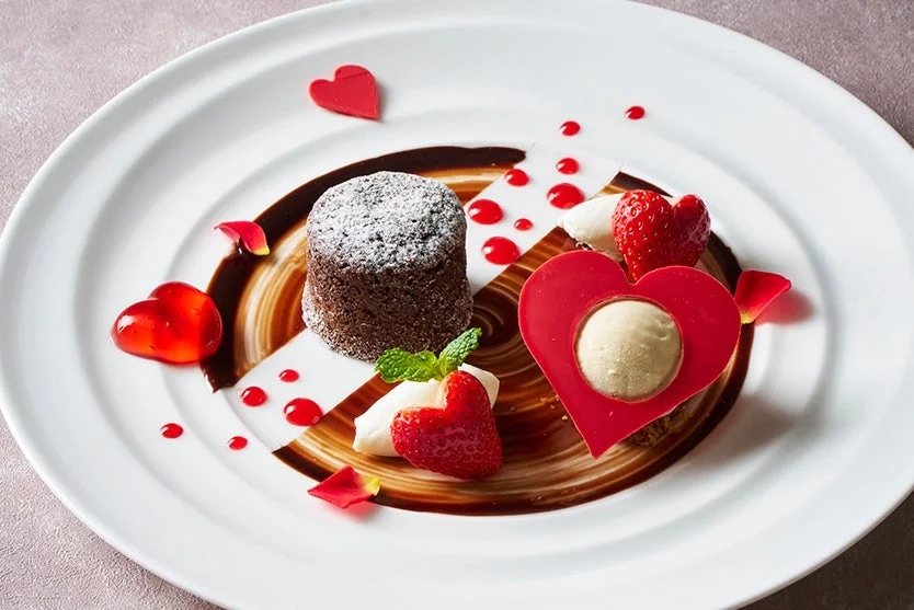 Decadent chocolate dessert with strawberries and a heart motif