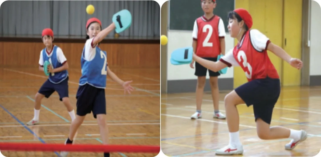 Children in red hats playing Tenipin in a gymnasium