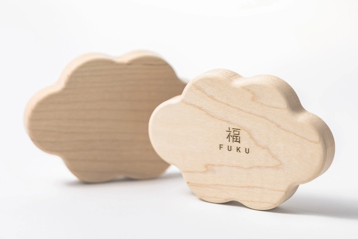 Cloud-shaped wooden pedestal with FUKU engraving