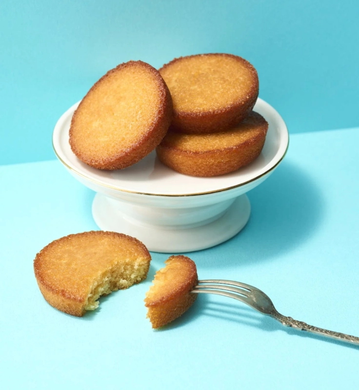 Golden financiers on a blue background