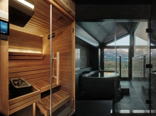 Modern interior with a sauna and bathtub overlooking snowy mountains