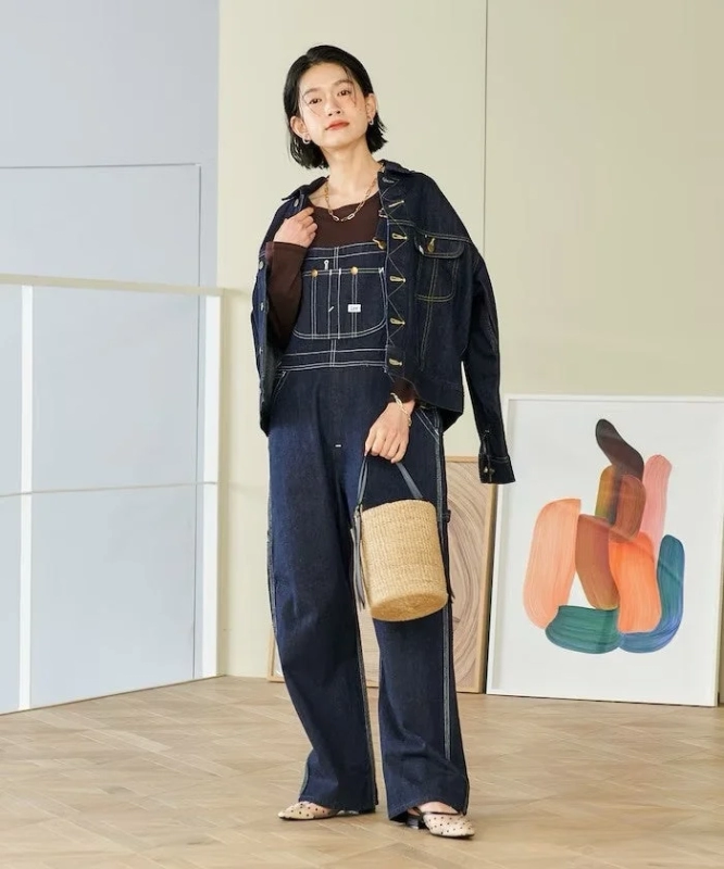 Female model in Lee denim overalls
