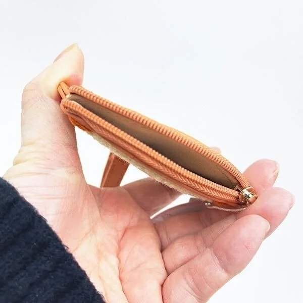 Hand opening the mini pouch