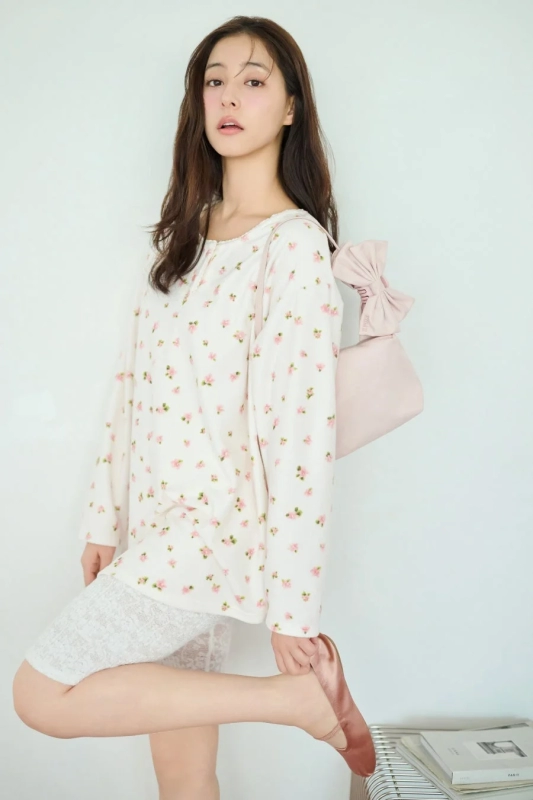 Model in floral top and shorts