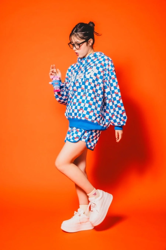 Model in checkerboard and cherry print Repipi Armario x Wiggle Wiggle collaboration set-up