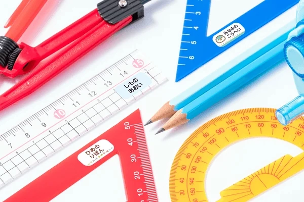 School supplies like rulers and compasses with name seals