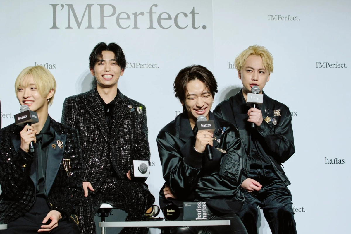 IMP. members smiling on stage at the HARIAS event