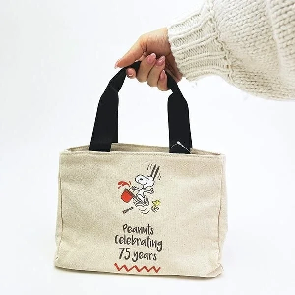 Woman holding Snoopy Tote Bag