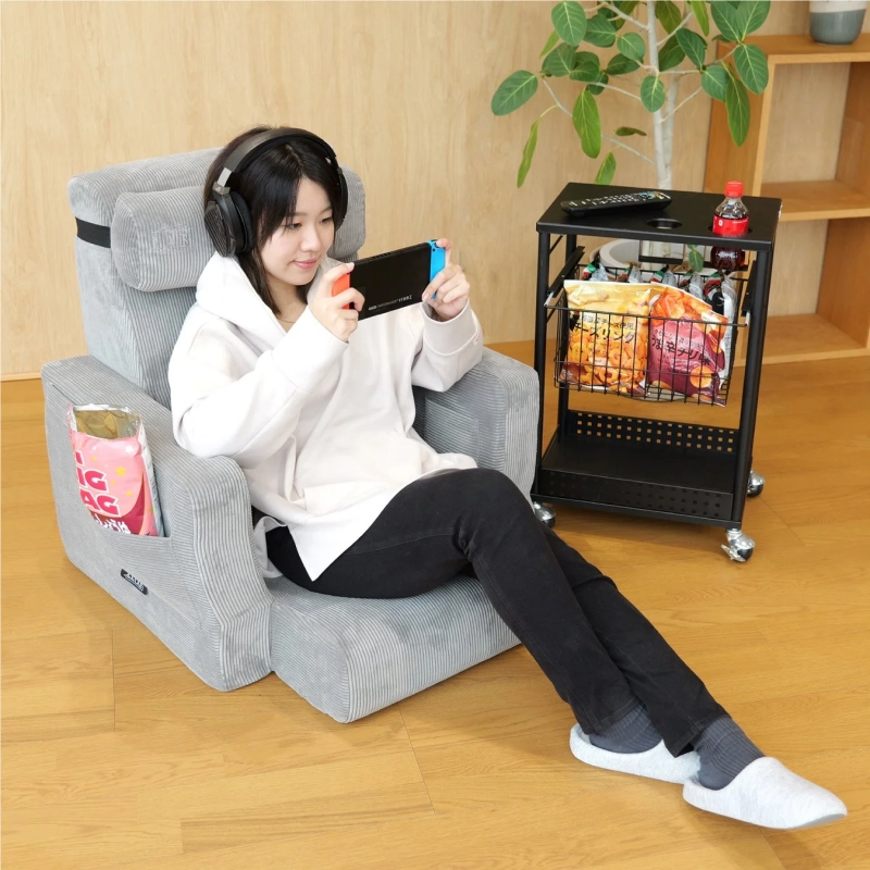 Woman gaming on a sofa chair
