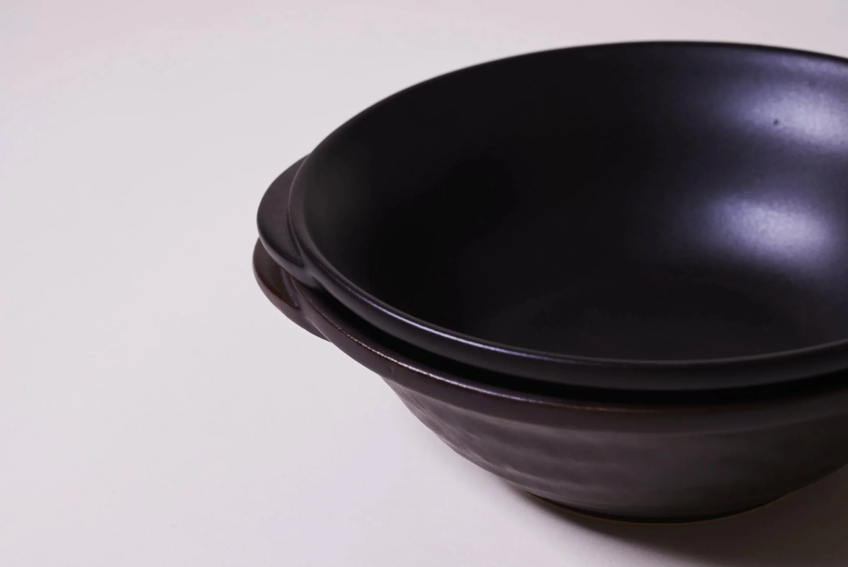 Two black KOKURYU donabe stacked