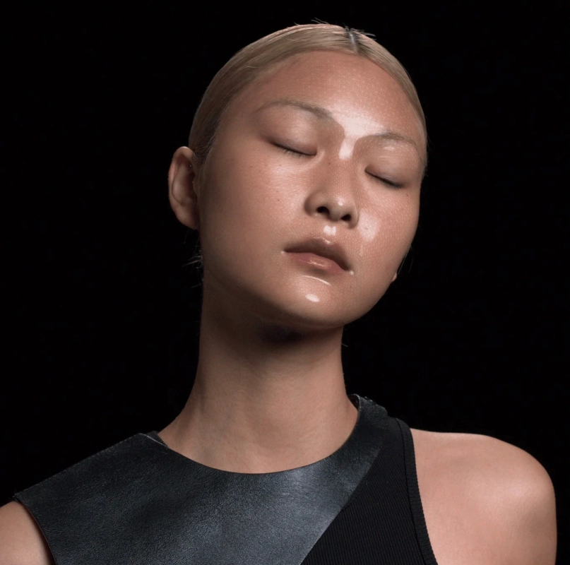 A close-up of a woman's face with glowing, smooth skin, representing the 'Glass Skin' concept